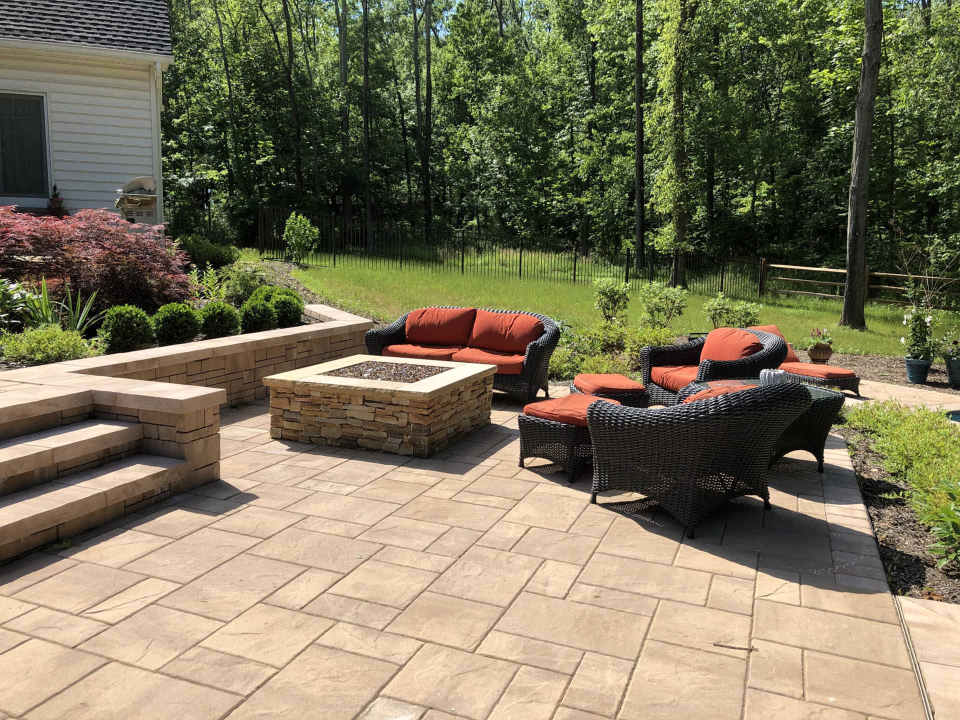 Paver patio with integrated steps and a low retaining wall